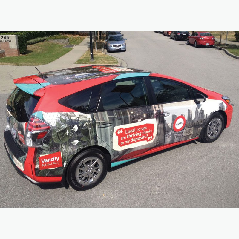 Red hatchback car with full graphic wrap