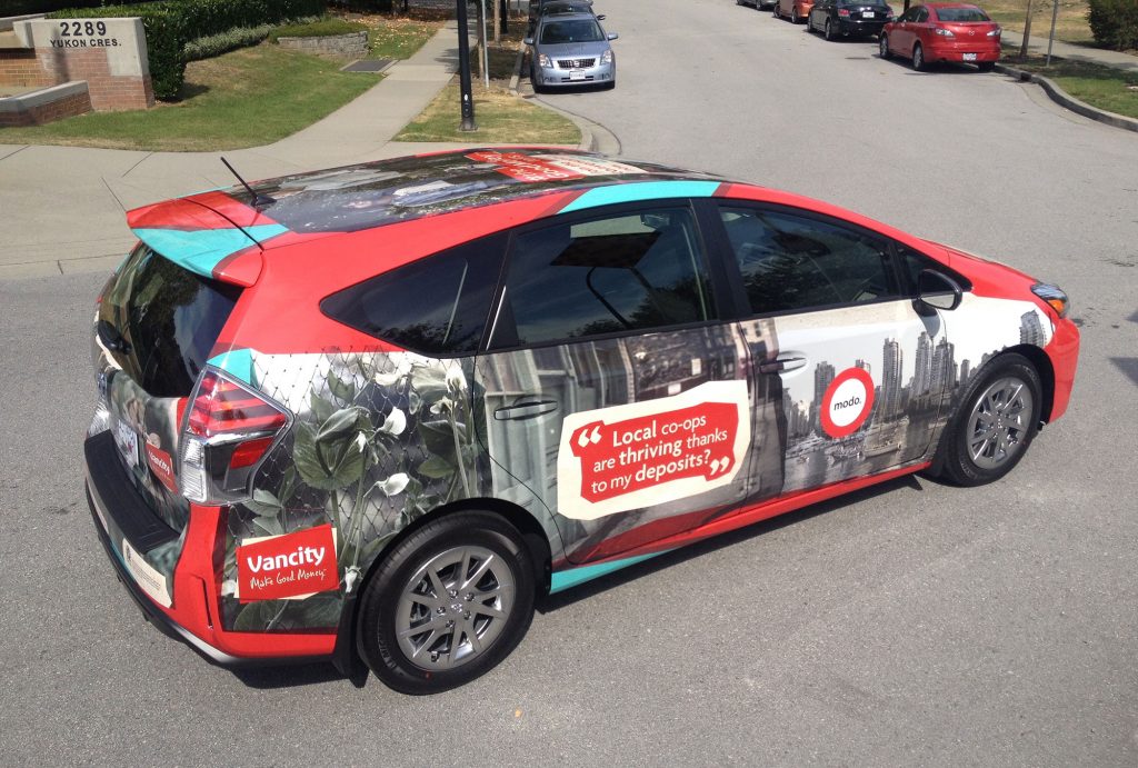 Red hatchback car with full graphic wrap