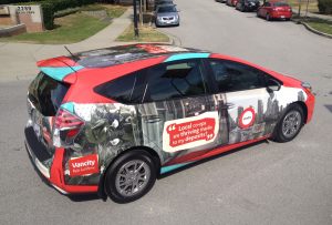 Red hatchback car with full graphic wrap