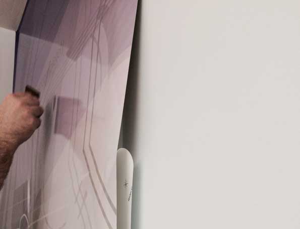 Installing vinyl wall graphic with a squeegee